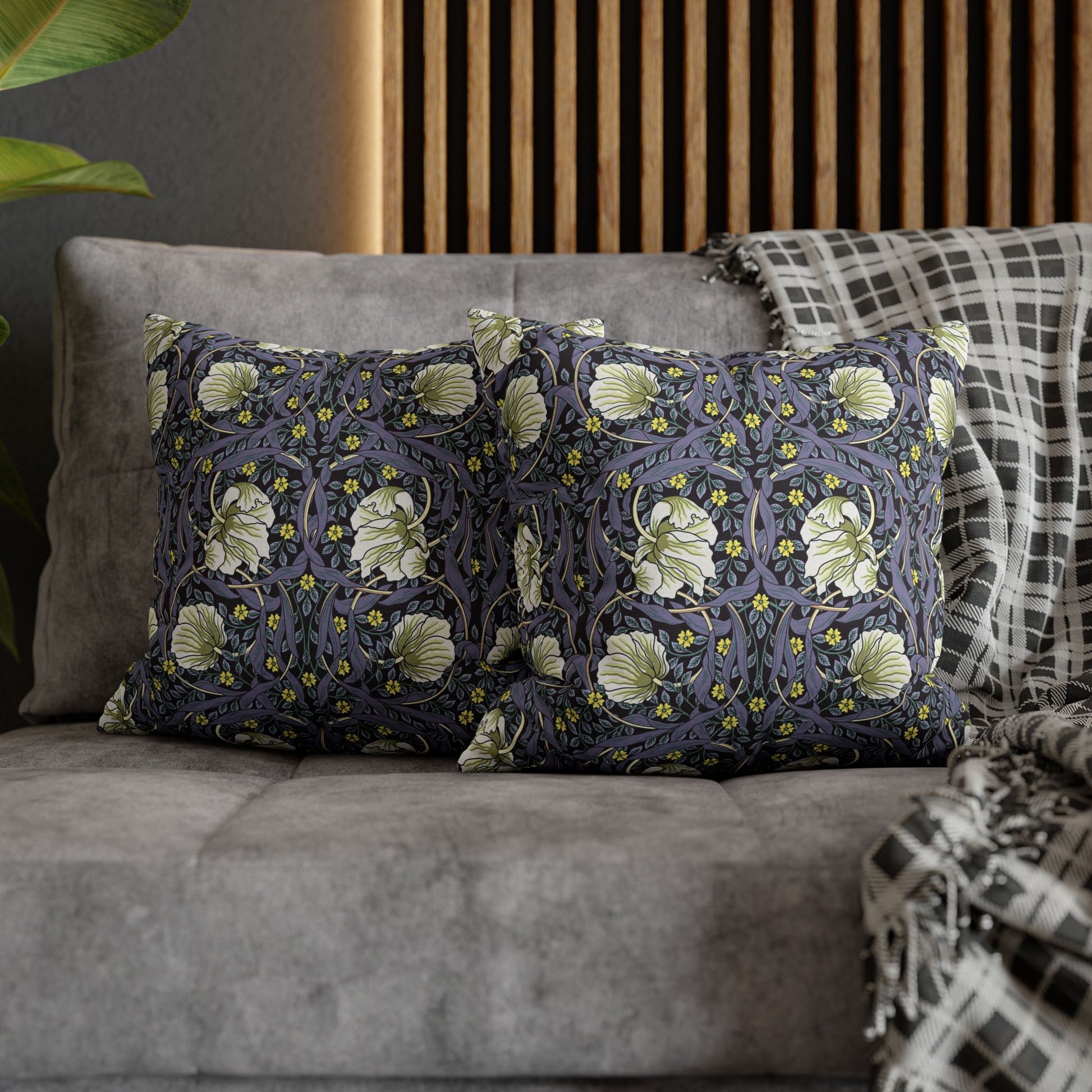 Decorative pillows with floral pattern on a gray sofa