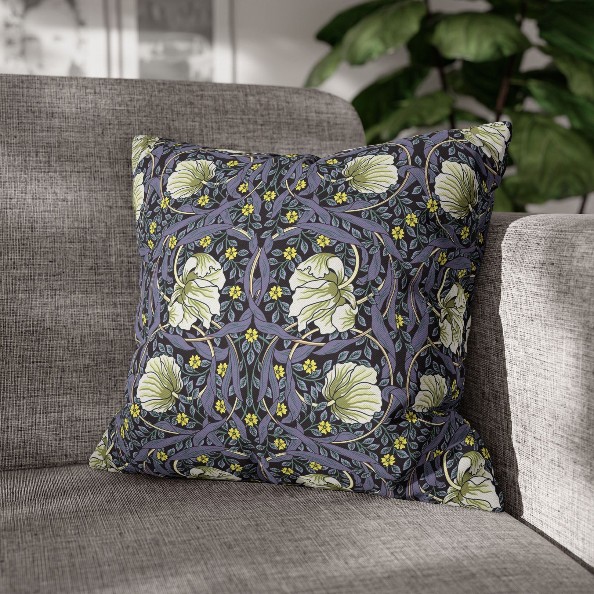 Decorative pillow with floral pattern on a gray sofa