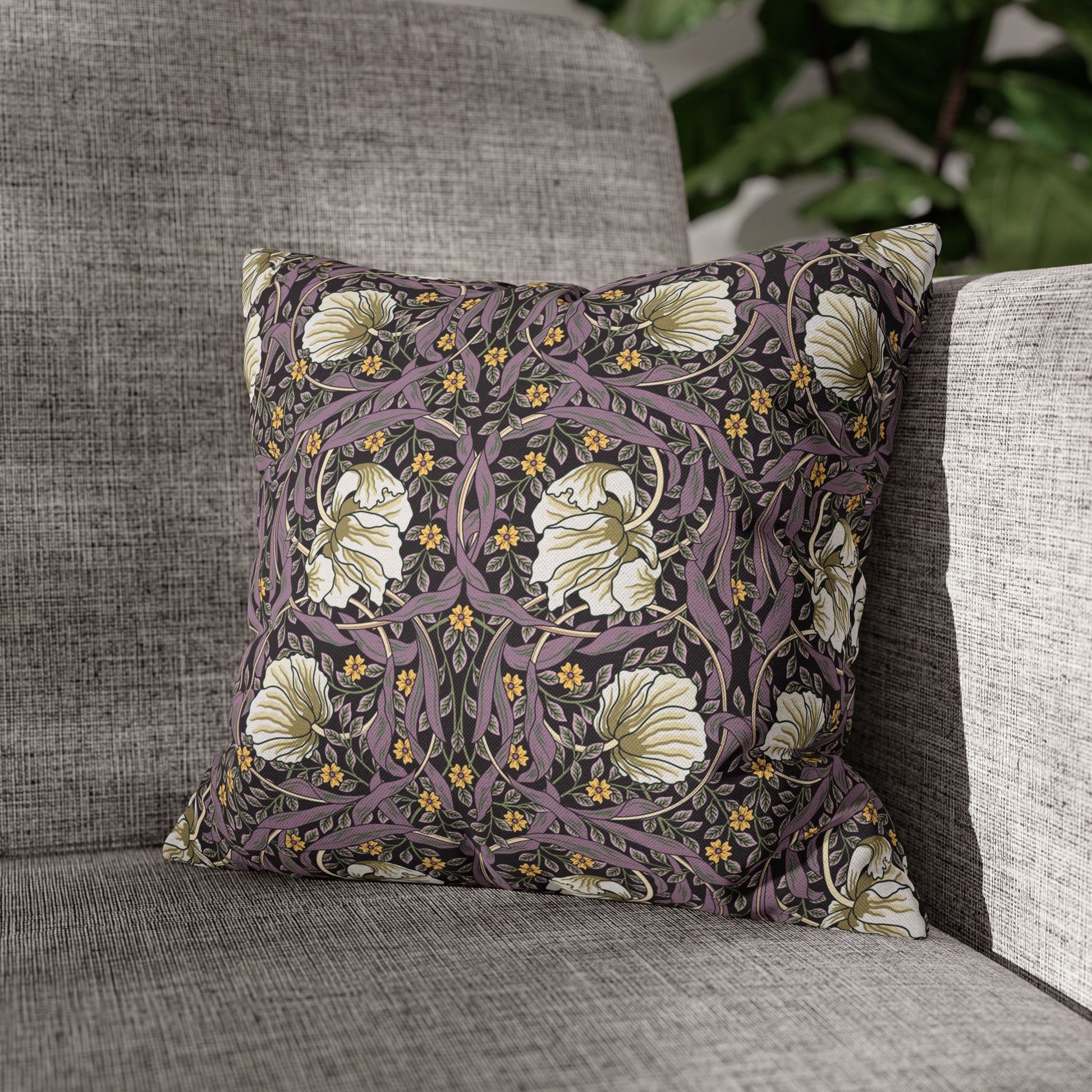 Decorative pillow with floral pattern on a gray sofa