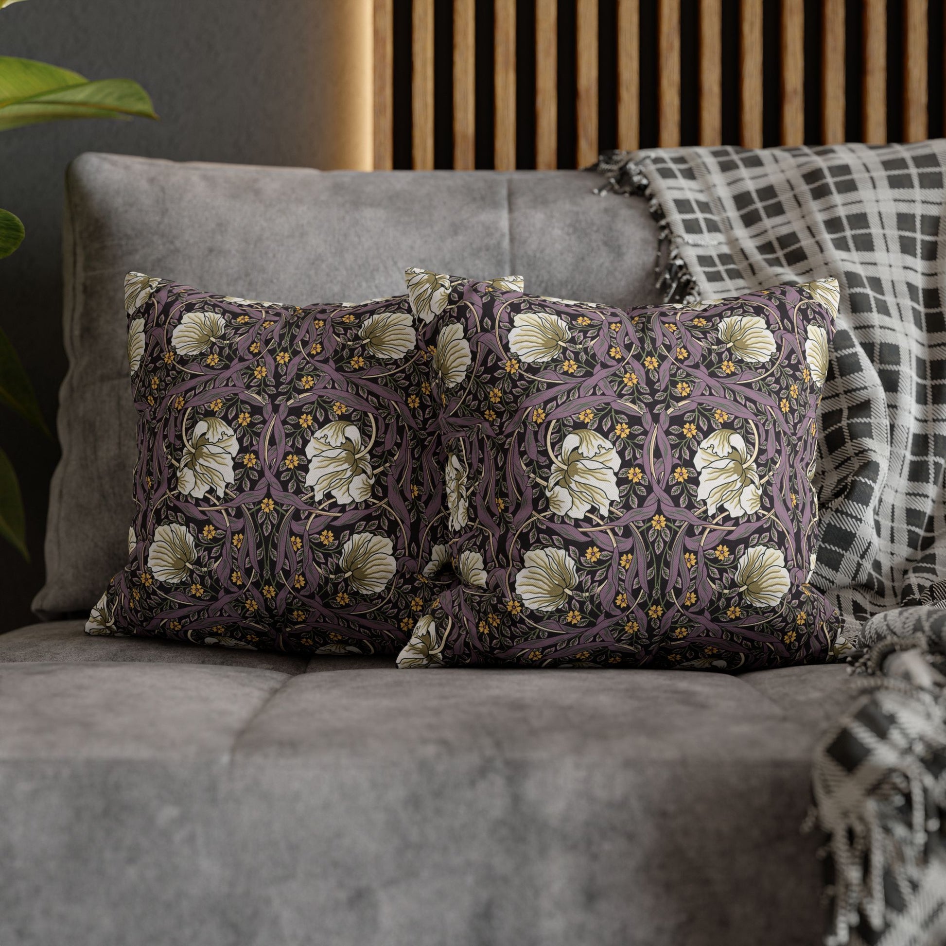 Decorative pillow with floral pattern on a gray sofa