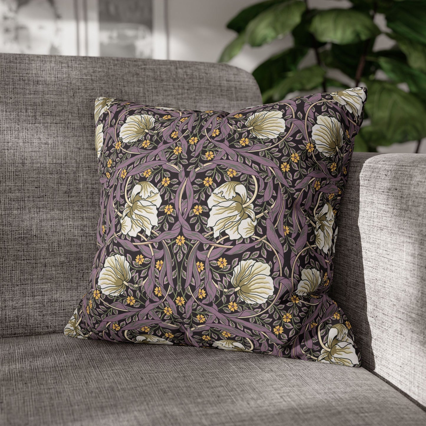 Decorative pillow with floral pattern on a gray sofa
