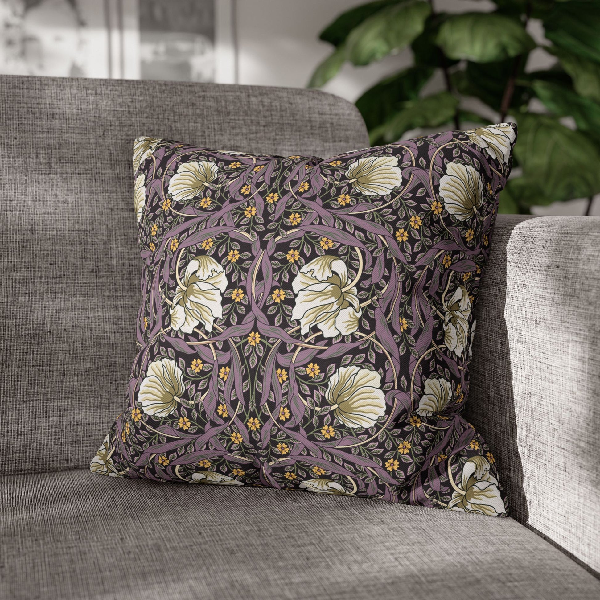 Decorative pillow with floral pattern on a gray sofa