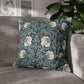 Floral patterned pillow on a gray sofa with a blurred indoor background