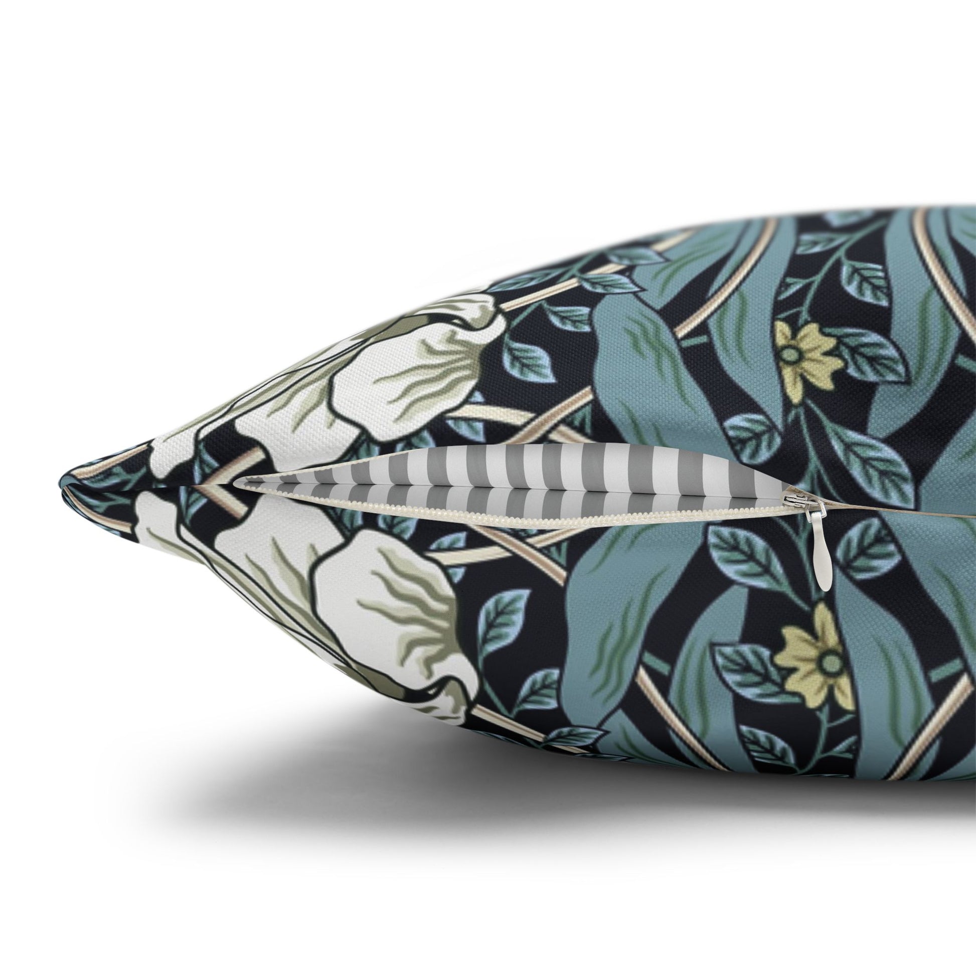 Decorative pillow with floral pattern and feathers on a white background