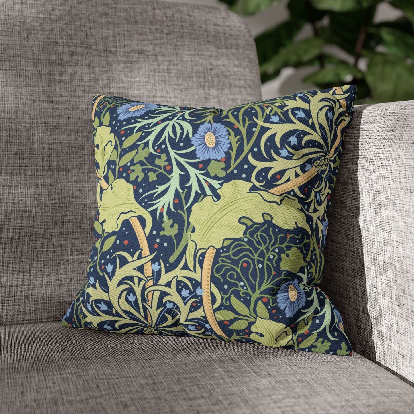 Decorative pillow with floral pattern on a gray sofa