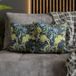 Decorative pillows with floral and animal pattern on a gray sofa.