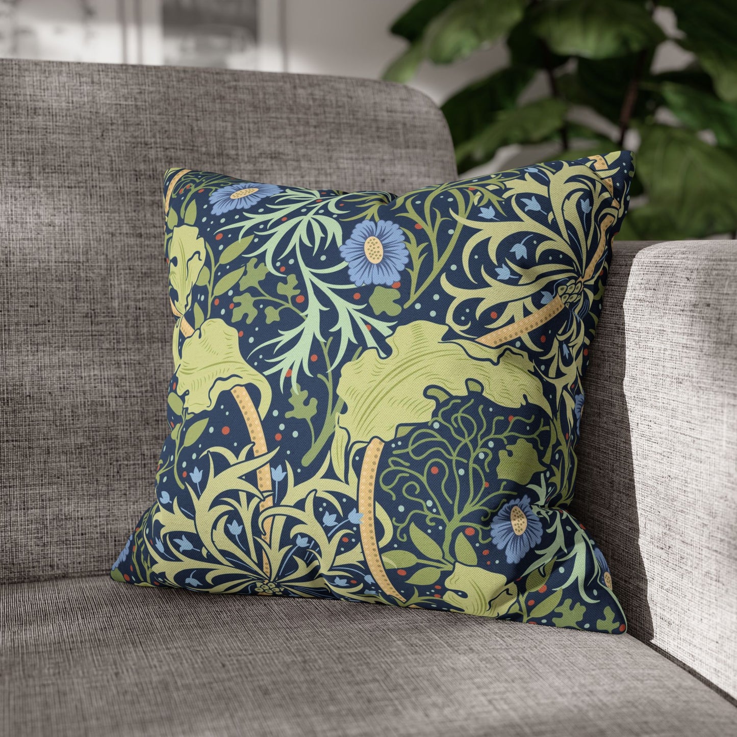 Decorative pillow with floral and animal pattern on a gray sofa