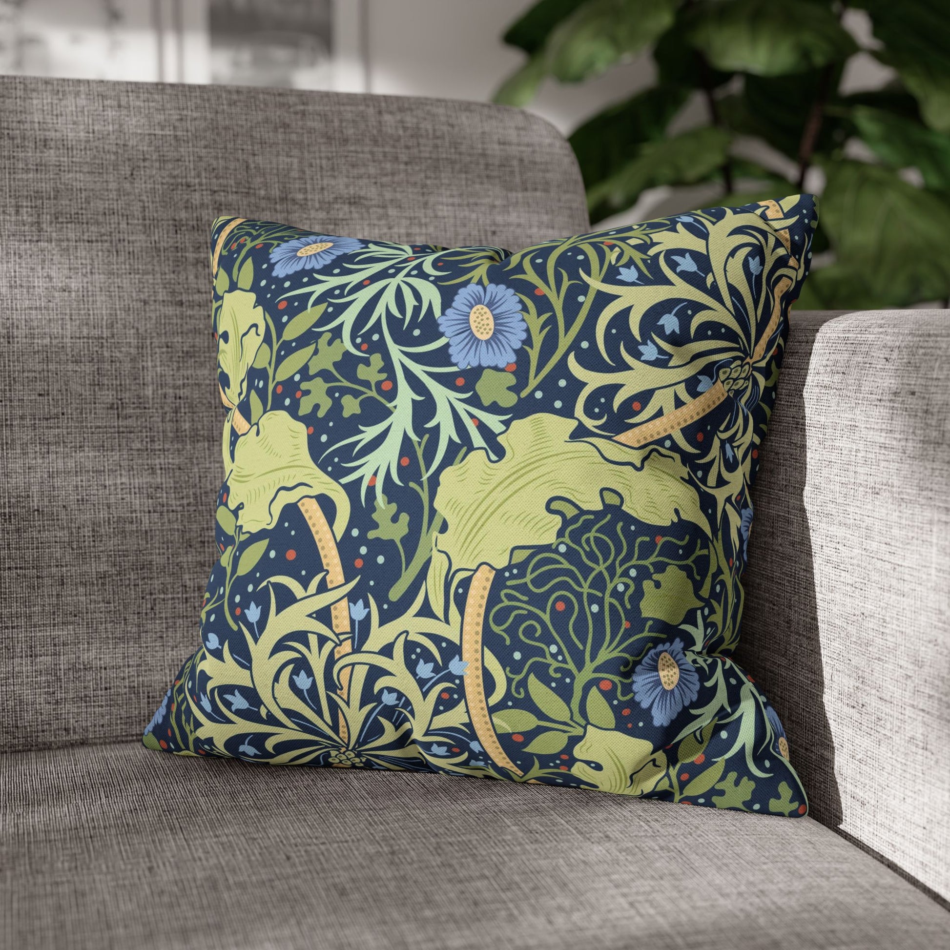 Decorative pillow with floral and animal pattern on a gray sofa