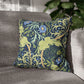 Decorative pillow with floral and animal pattern on a gray sofa