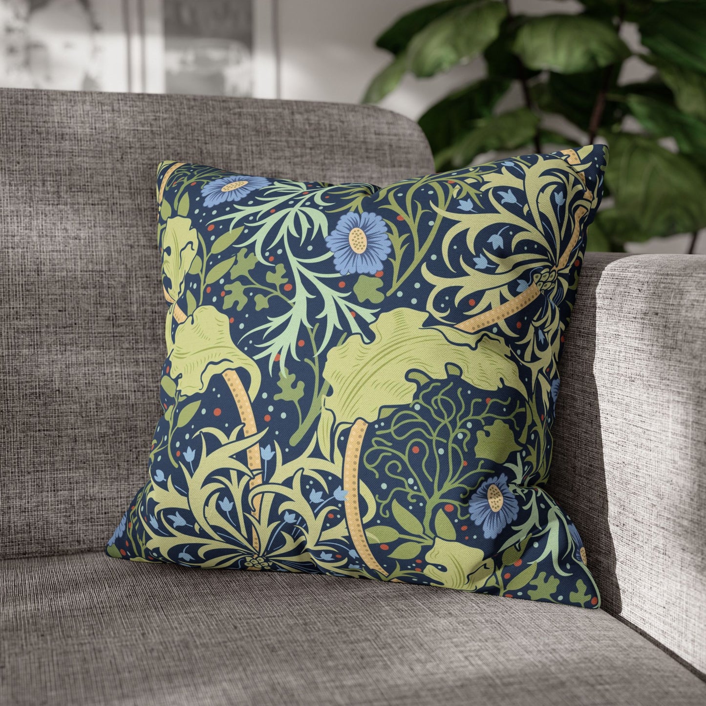 Decorative pillow with floral and animal pattern on a gray sofa