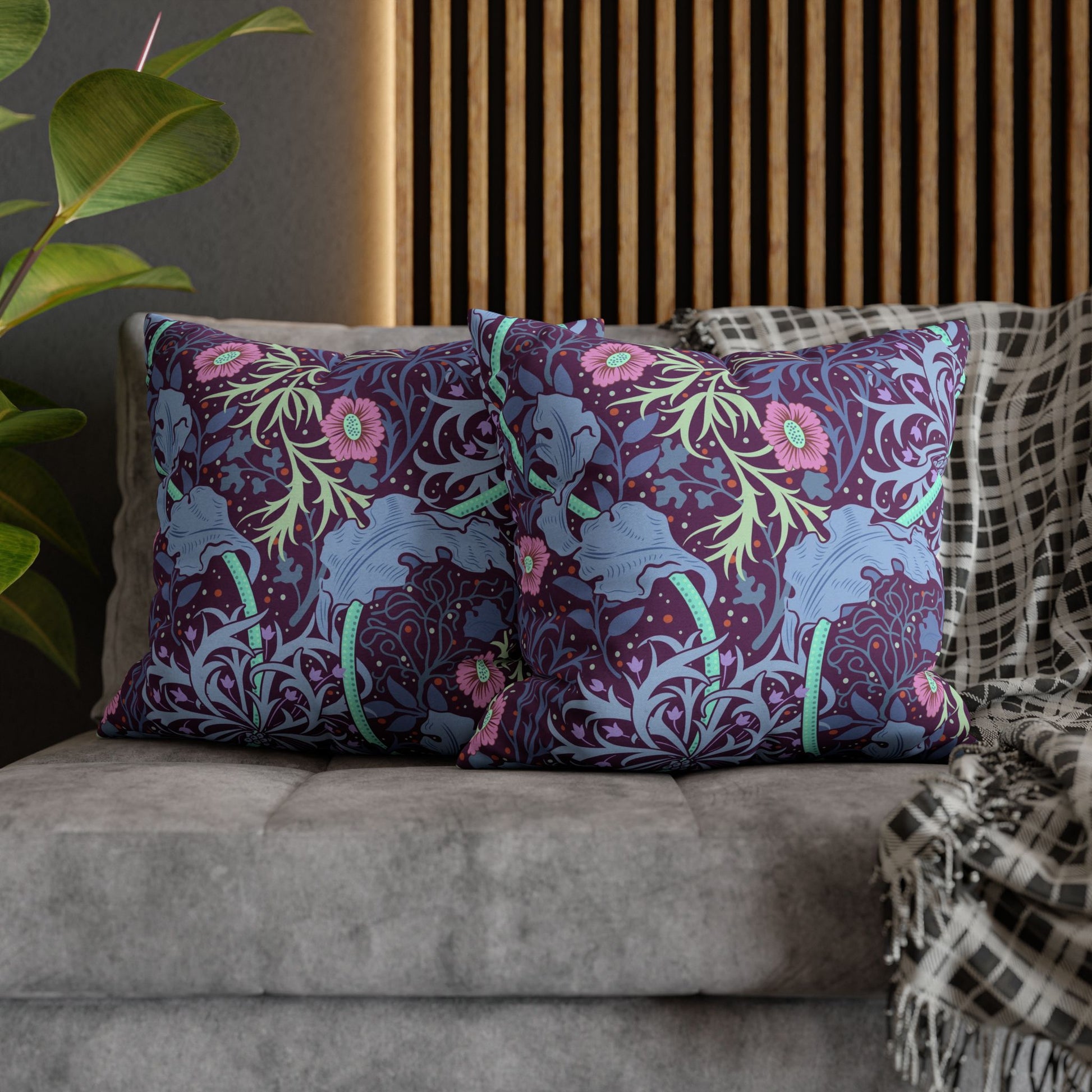 Decorative pillows with elephant and floral pattern on a sofa