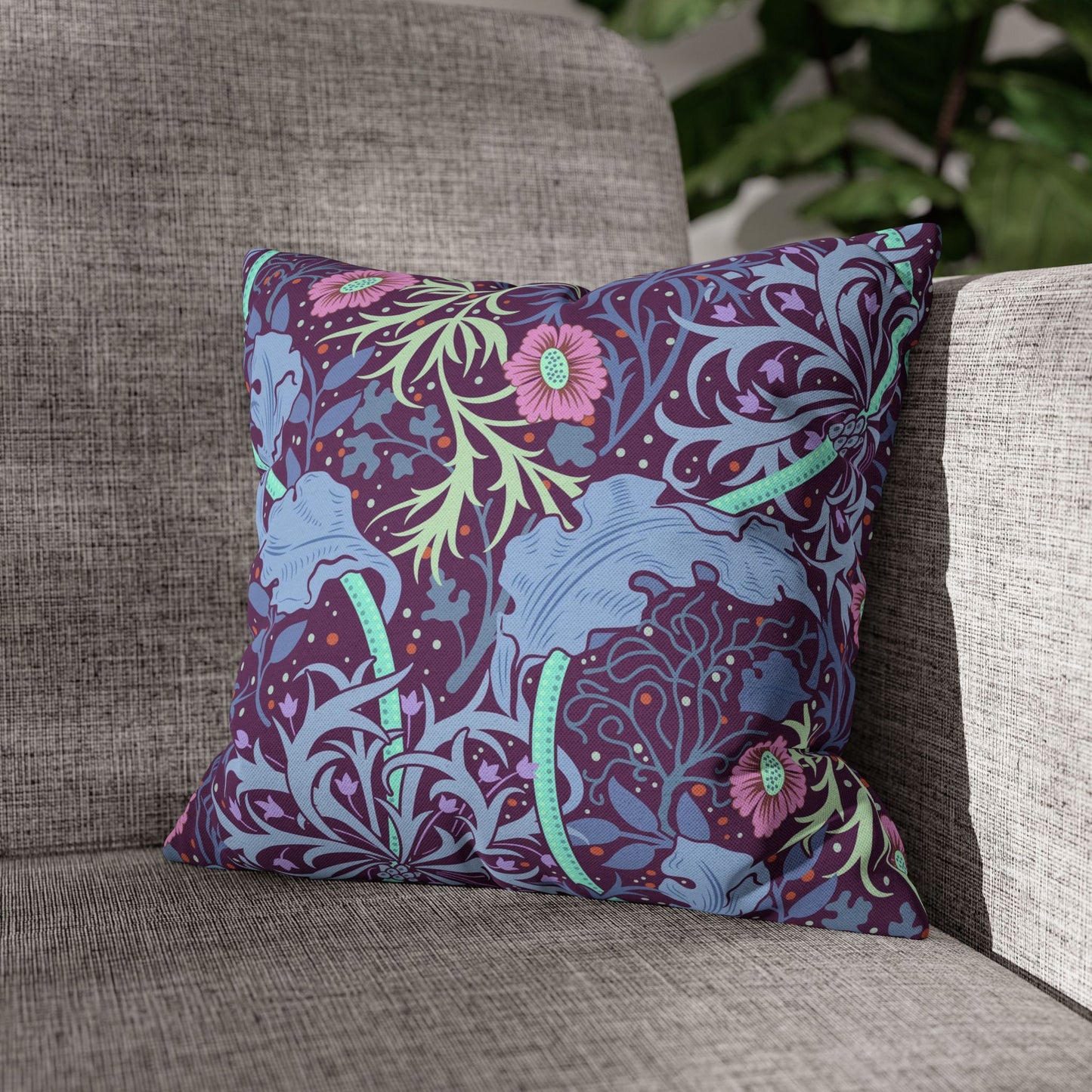 Decorative pillow with floral pattern on a gray couch