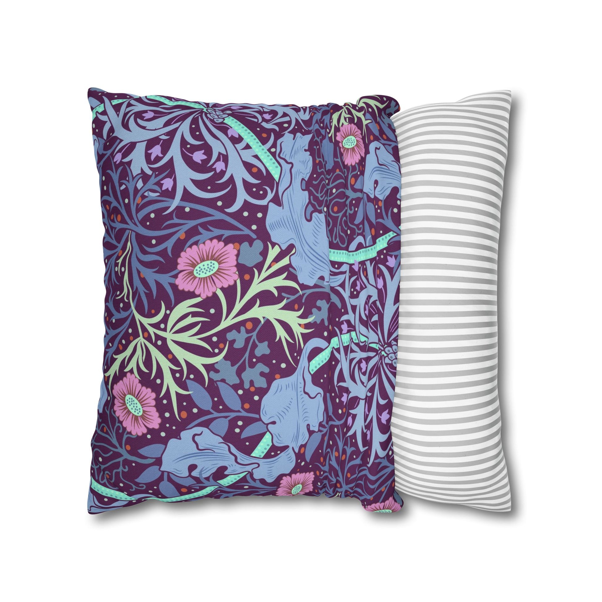 Two pillows, one with a floral and elephant pattern and the other with a striped pattern, on a white background.