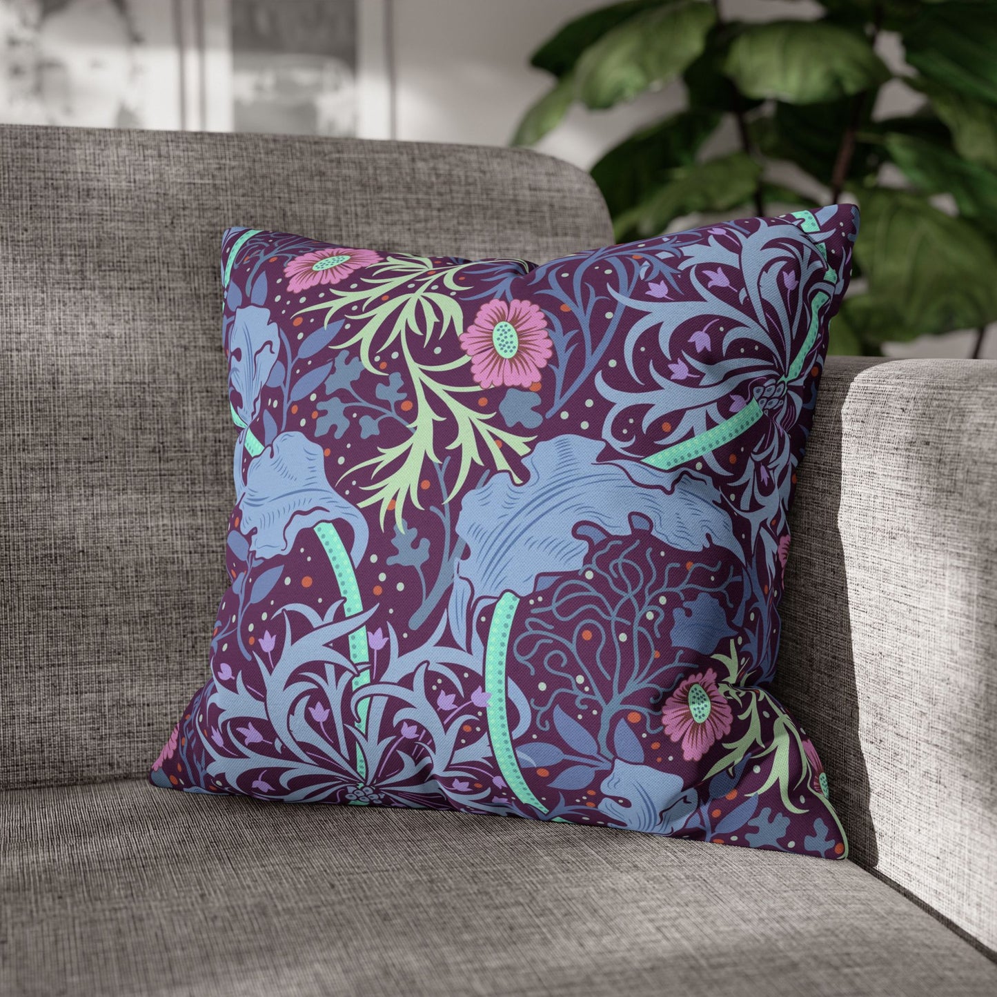 Decorative pillow with floral and animal pattern on a gray sofa