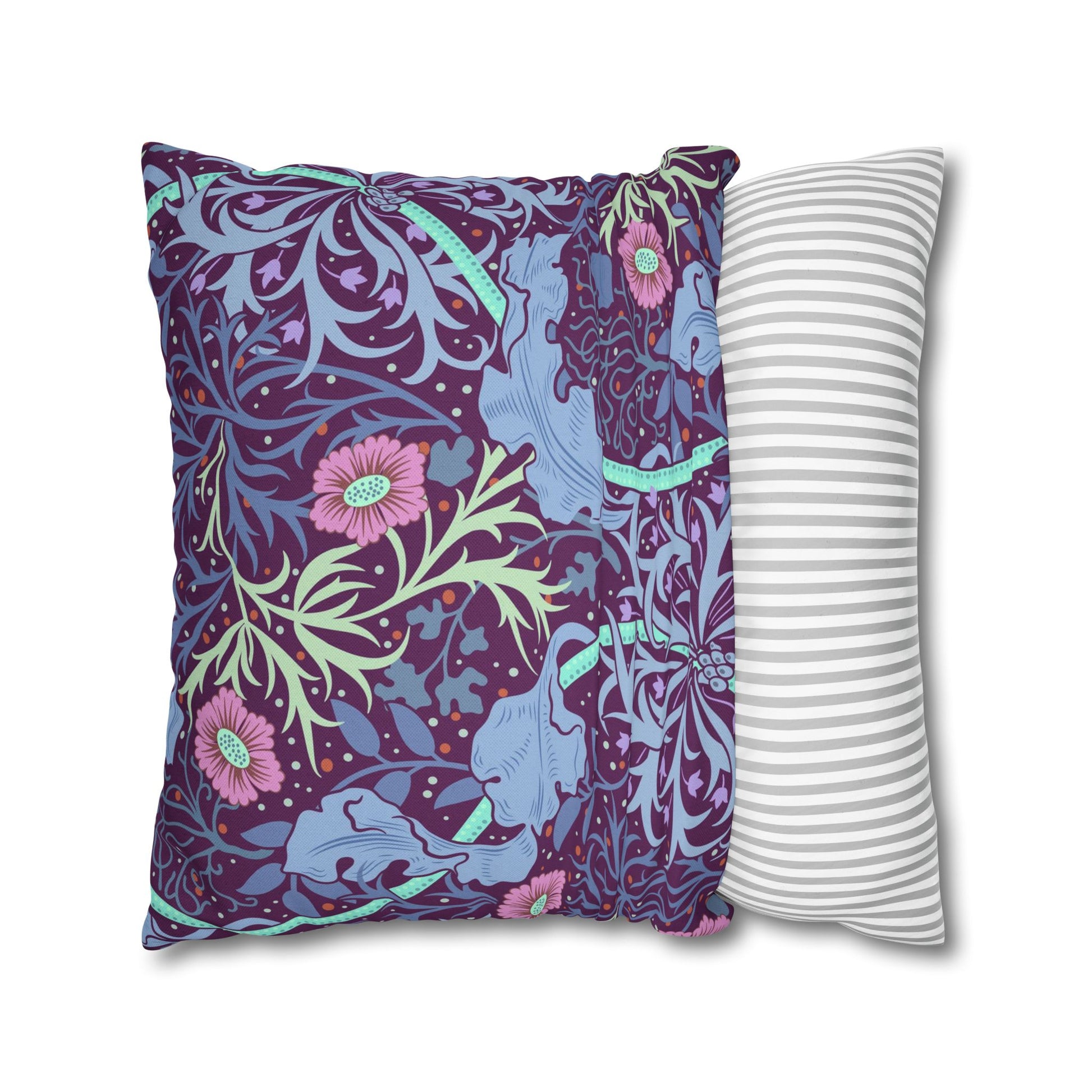 Two pillows, one with a colorful floral pattern and the other with a white and gray striped pattern, on a white background.