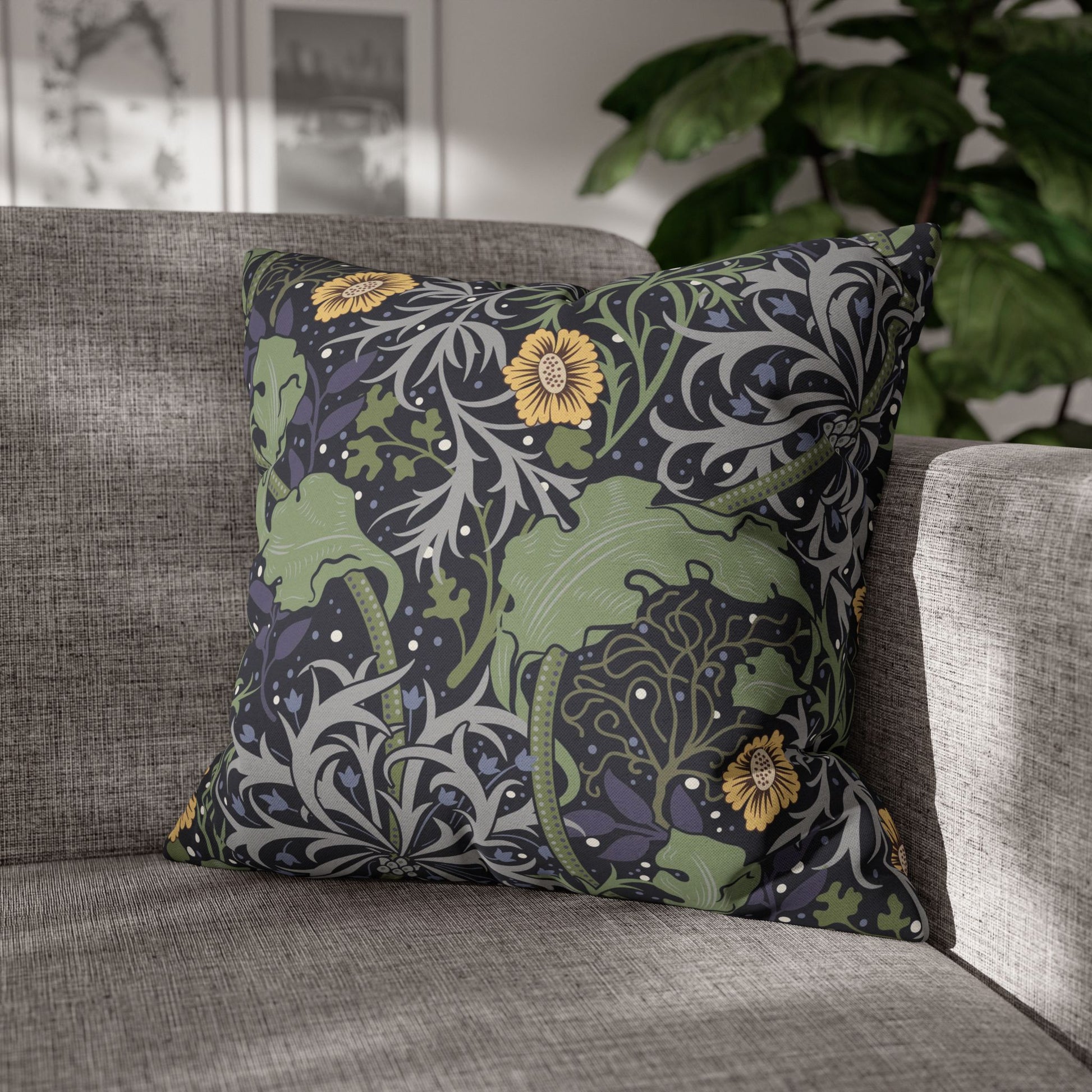 Decorative pillow with floral pattern on a gray sofa