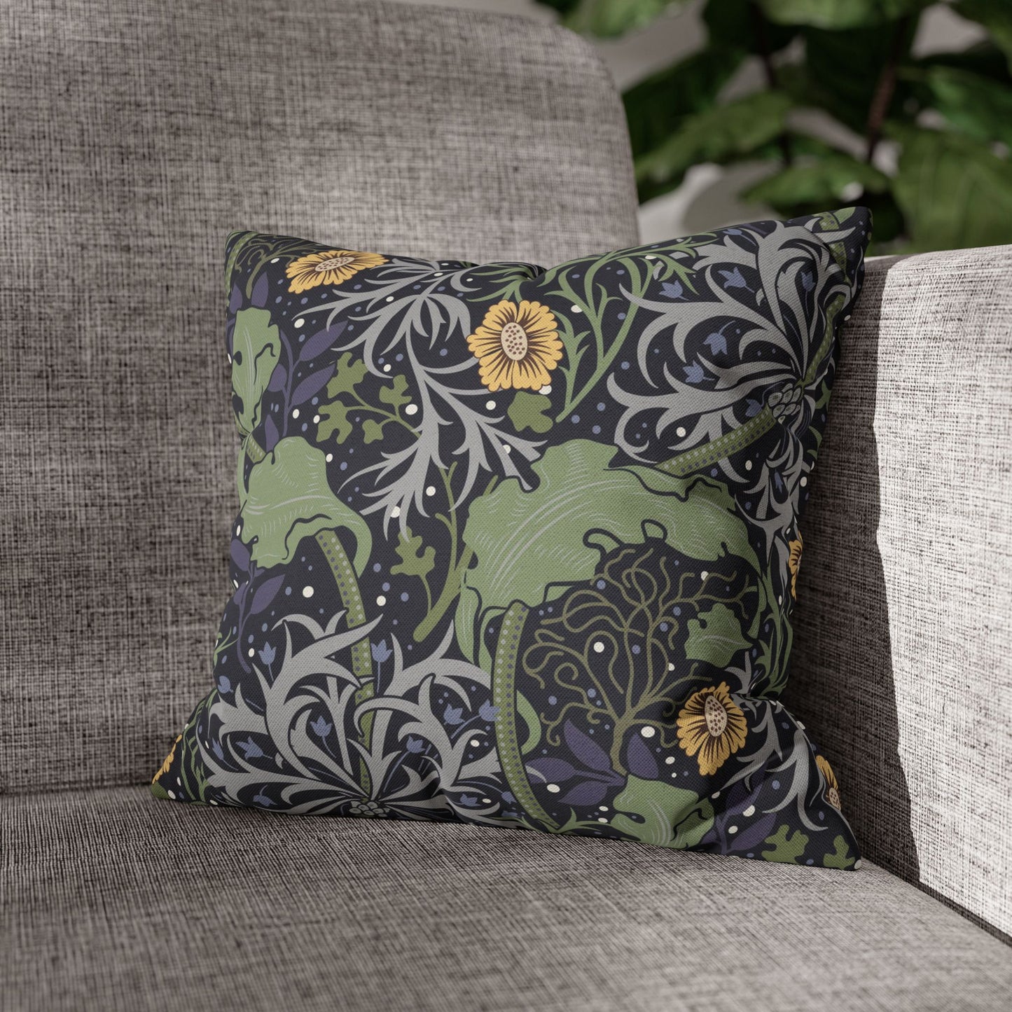 Decorative pillow with floral pattern on a gray sofa