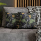 Decorative pillows with floral and animal pattern on a gray sofa.