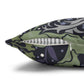 Decorative pillow with a green and purple pattern on a white background