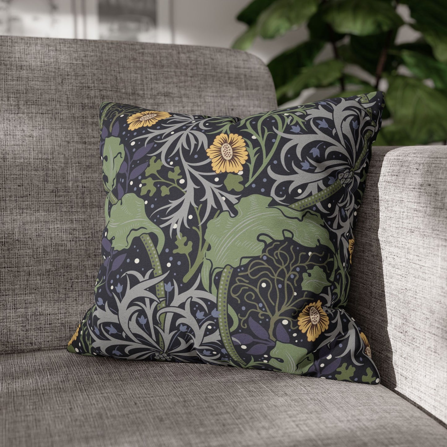 Decorative pillow with floral pattern on a gray sofa