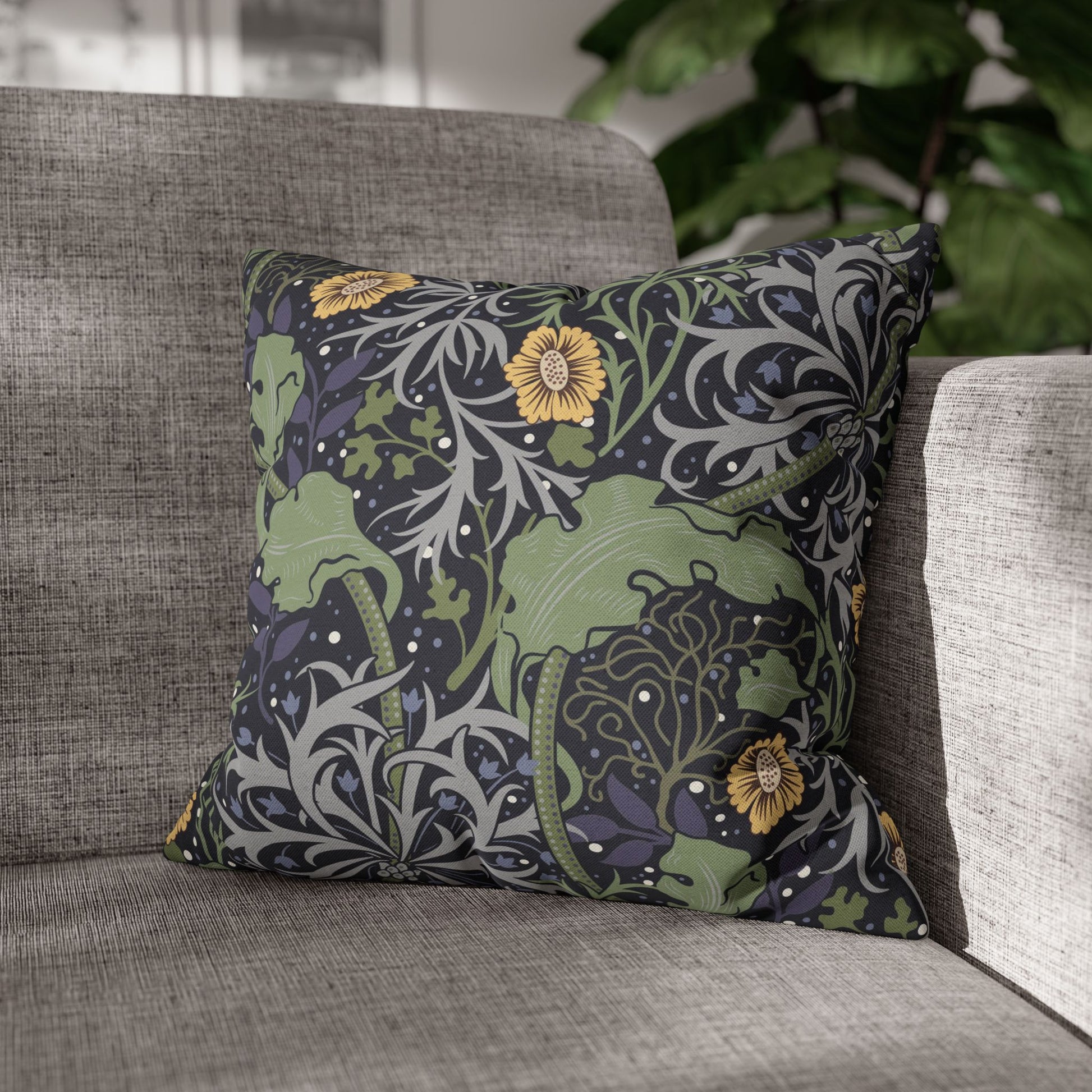 Decorative pillow with floral pattern on a gray sofa