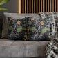 Decorative pillows with nature-themed patterns on a gray sofa.