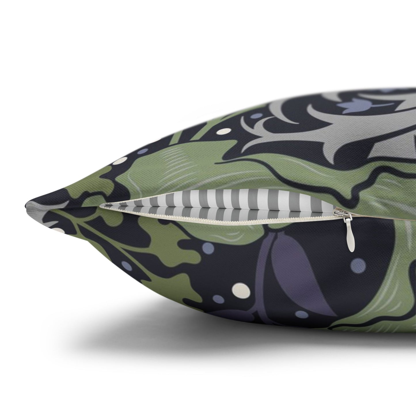 Decorative pillow with a green and black abstract pattern on a white background