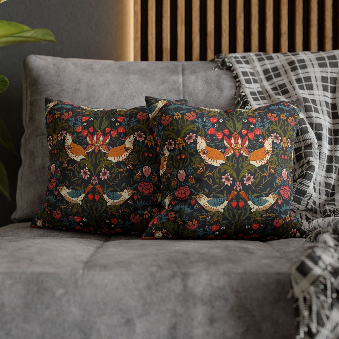 Decorative pillows with floral patterns on a gray sofa.