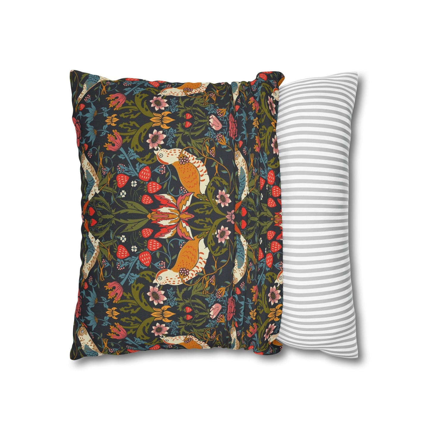 Decorative pillow with floral and fox pattern next to a striped pillow on a white background