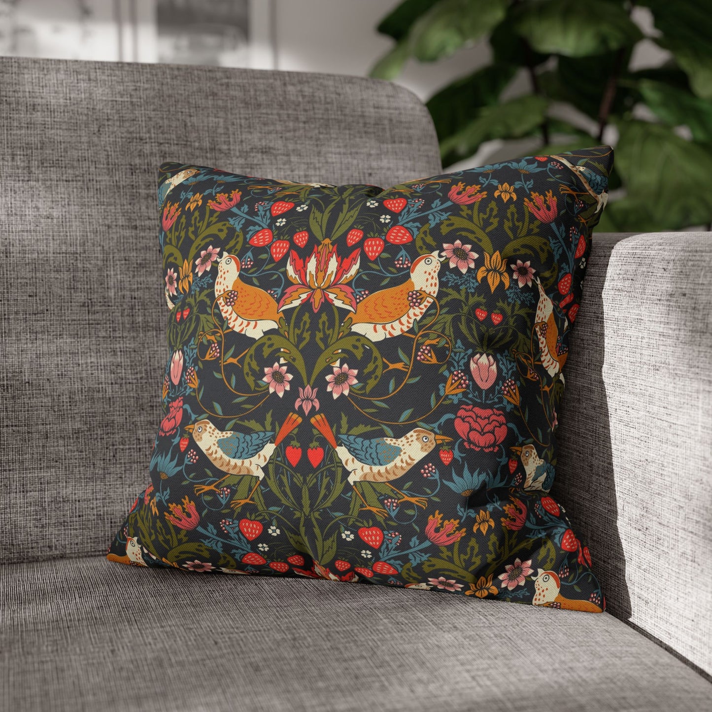 Decorative pillow with floral and bird pattern on a gray sofa