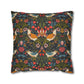 Decorative pillow with intricate floral and bird pattern on a dark background