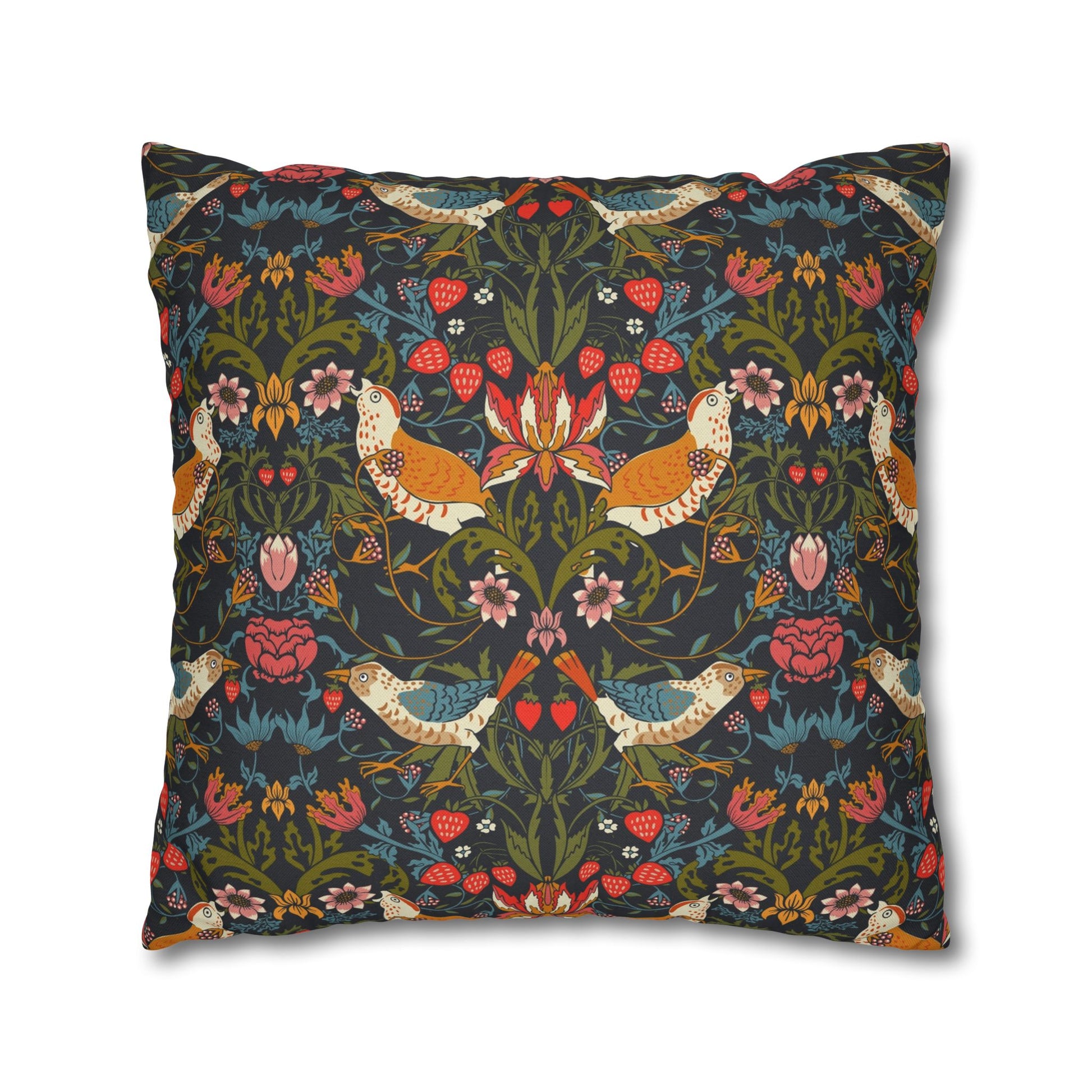 Decorative pillow with intricate floral and bird pattern on a dark background