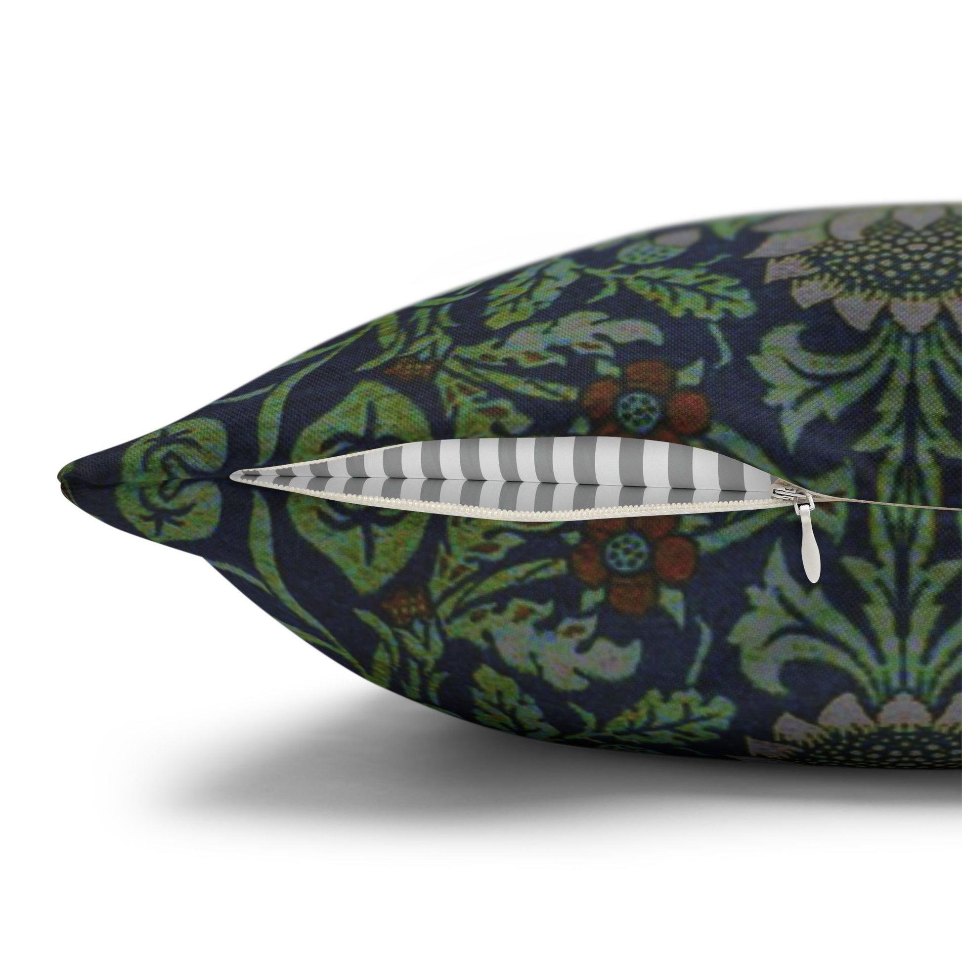 Decorative pillow with floral pattern and a feather on a white background