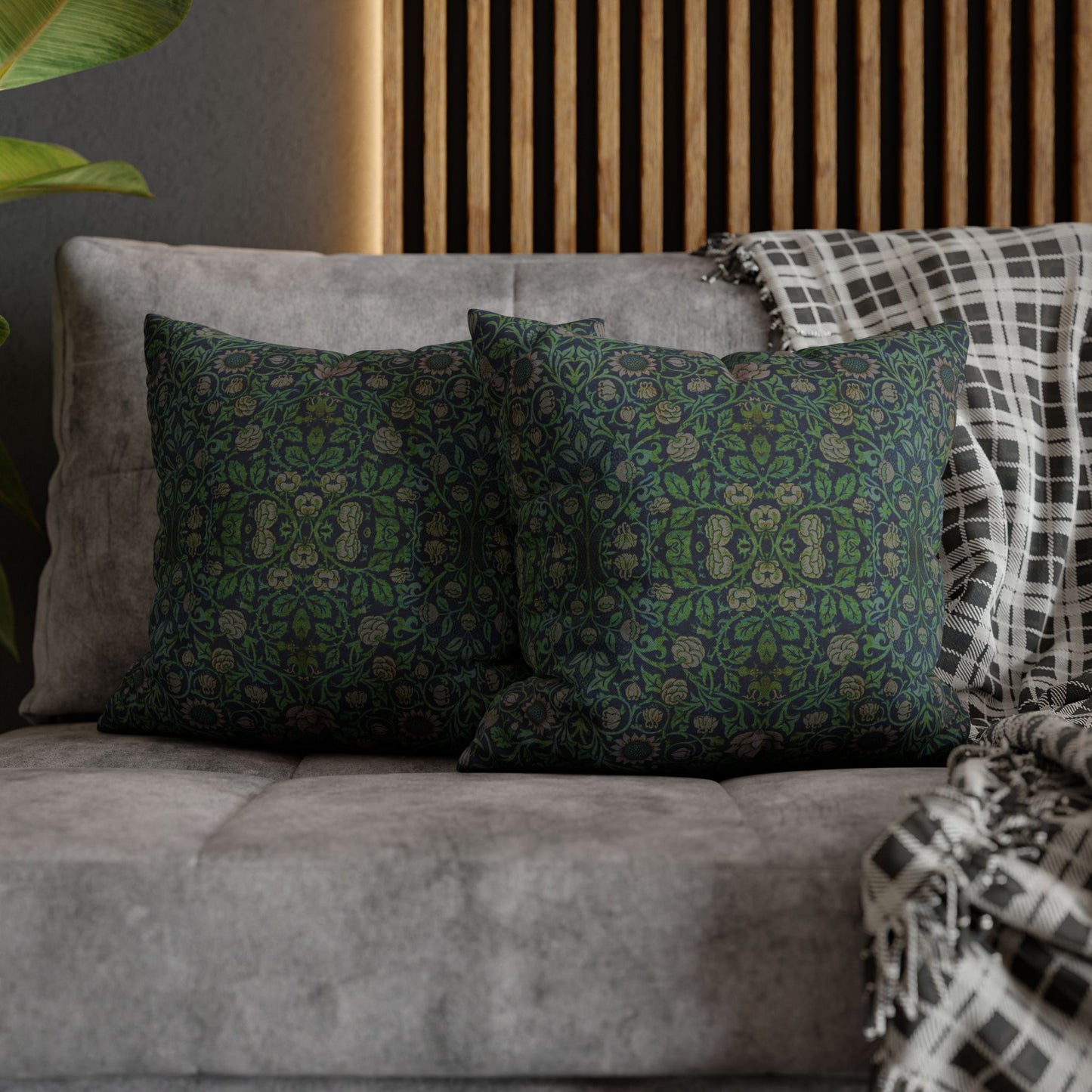Decorative pillows on a gray sofa with a wooden headboard in the background