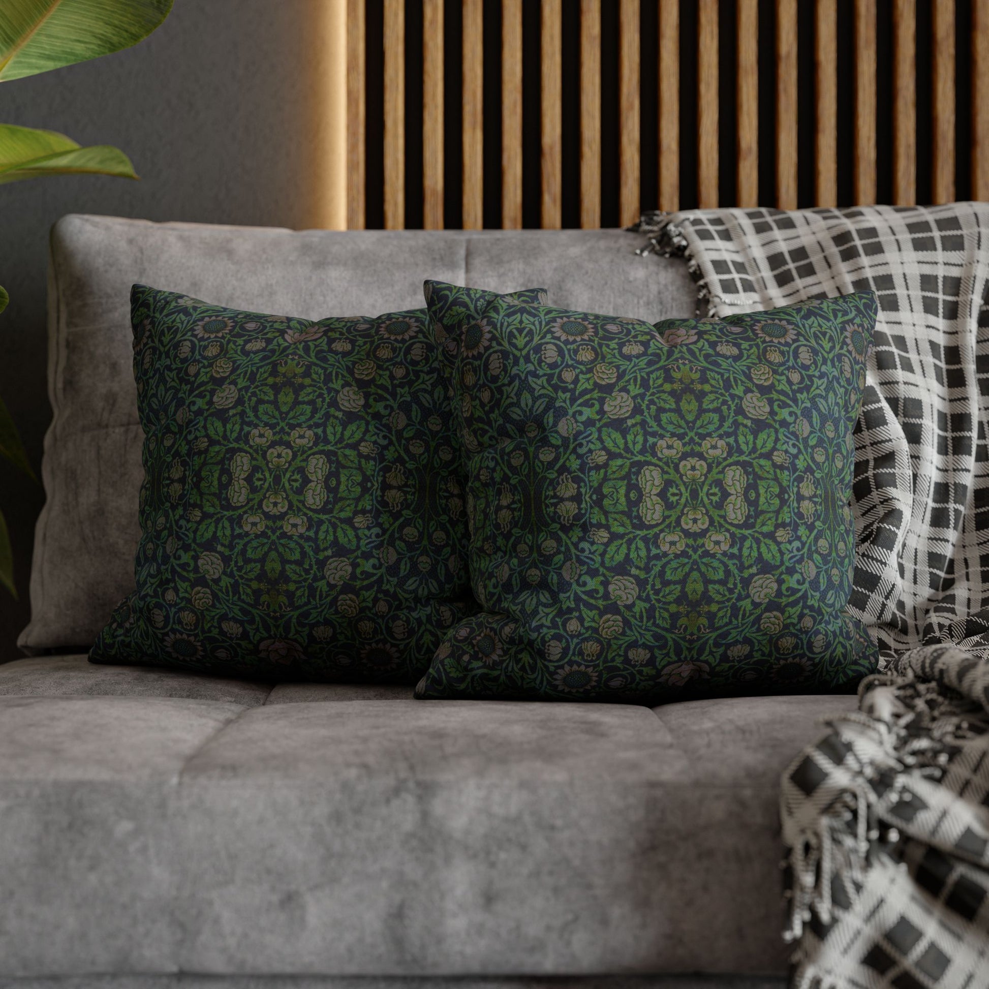Decorative pillows on a gray sofa with a wooden headboard in the background