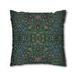 Decorative pillow with intricate green and blue pattern on a white background