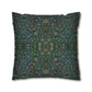 Decorative pillow with intricate green and blue pattern on a white background