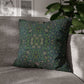 Decorative green pillow with floral pattern on a gray sofa