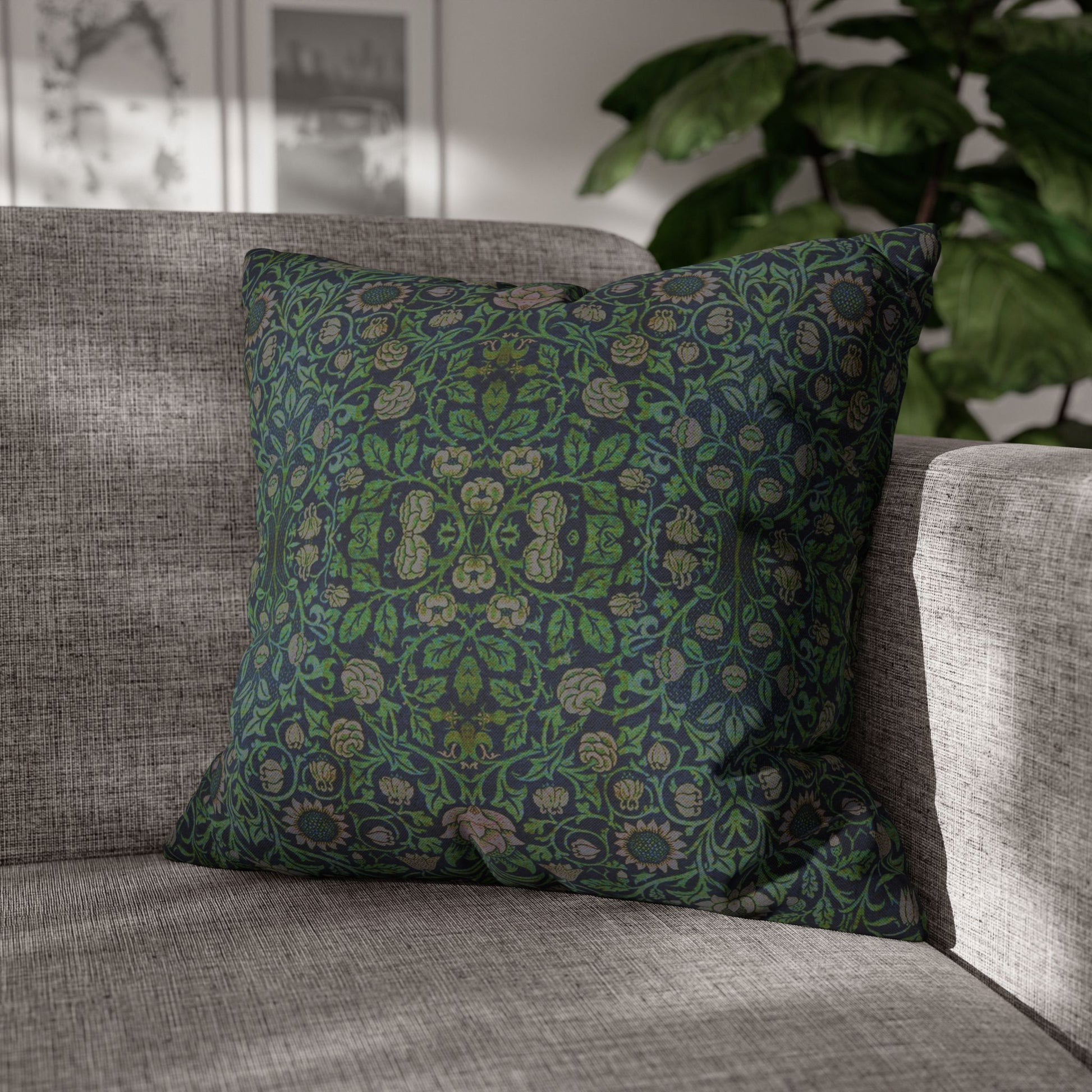 Decorative green pillow with floral pattern on a gray sofa