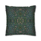 Decorative pillow with intricate green and blue pattern on a white background