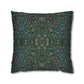 Decorative pillow with intricate green and blue pattern on a white background