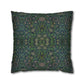 Decorative pillow with intricate green and blue pattern on a white background