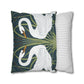 Decorative pillow with swan design next to a striped pillow on a white background