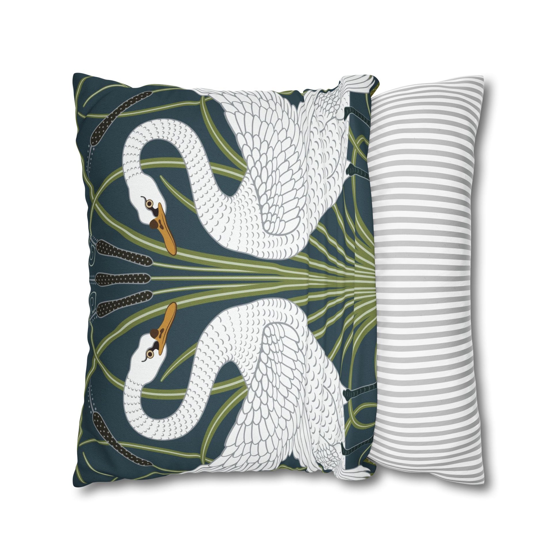 Decorative pillow with swan design next to a striped pillow on a white background