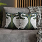 Decorative pillows with swan design on a gray sofa