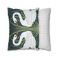 Decorative pillow with swan design next to a striped pillow on a white background