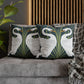 Decorative pillows with swan design on a gray sofa