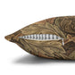 Decorative pillow with floral pattern and striped inner lining on a white background