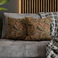 Decorative pillows on a gray sofa with a wooden headboard in the background
