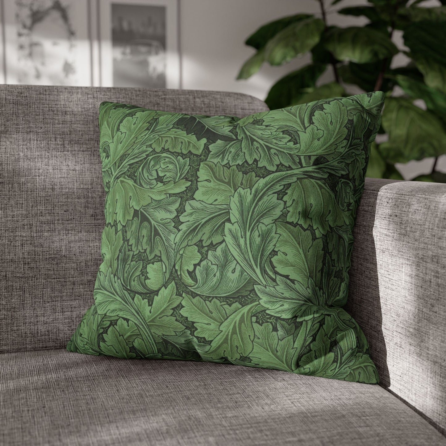 Green patterned pillow on a gray sofa with a blurred indoor background